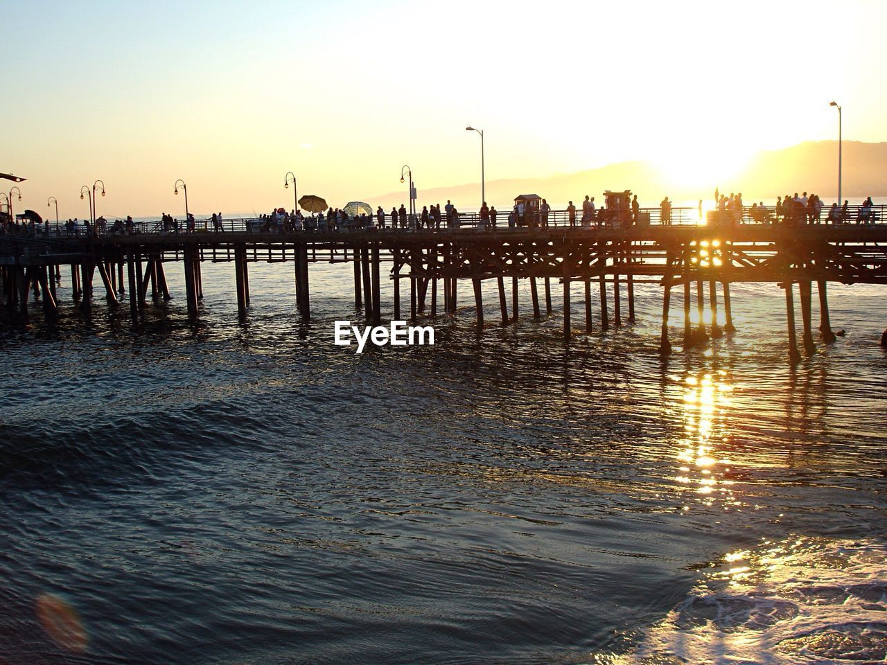 Pier on sea at sunset