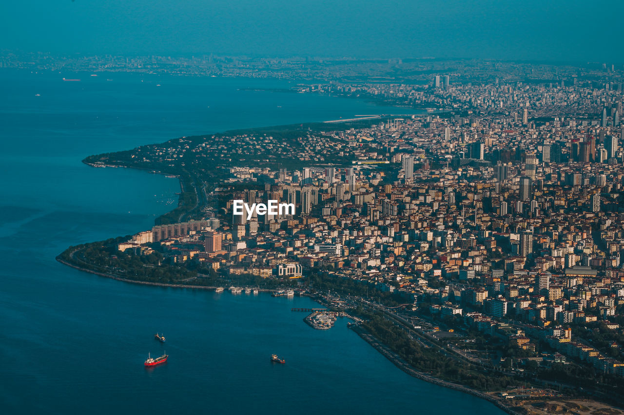 HIGH ANGLE VIEW OF CITY BUILDINGS AT WATERFRONT