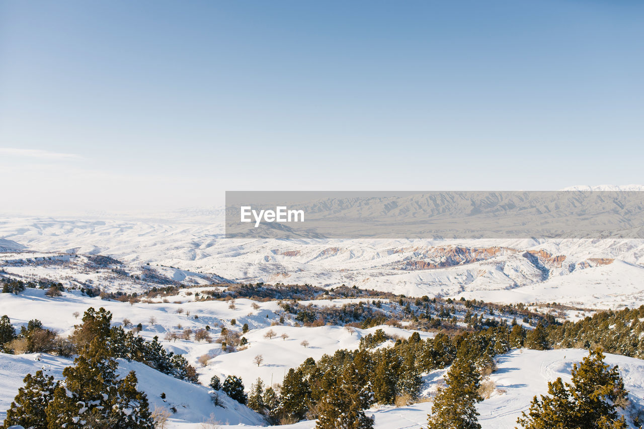 Panorama of snowy slopes covered with snow in sunny weather. winter landscape in the mountains