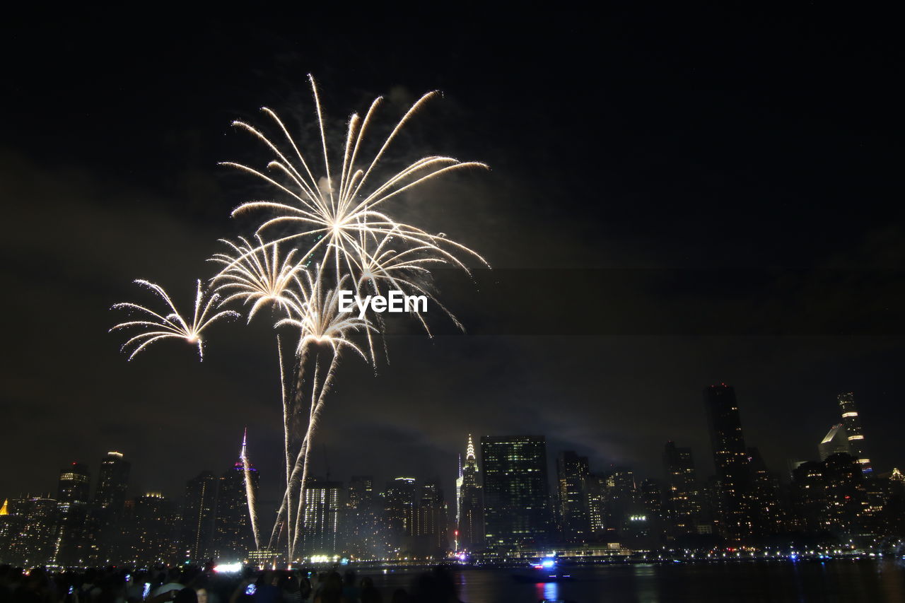 Low angle view of firework display at night