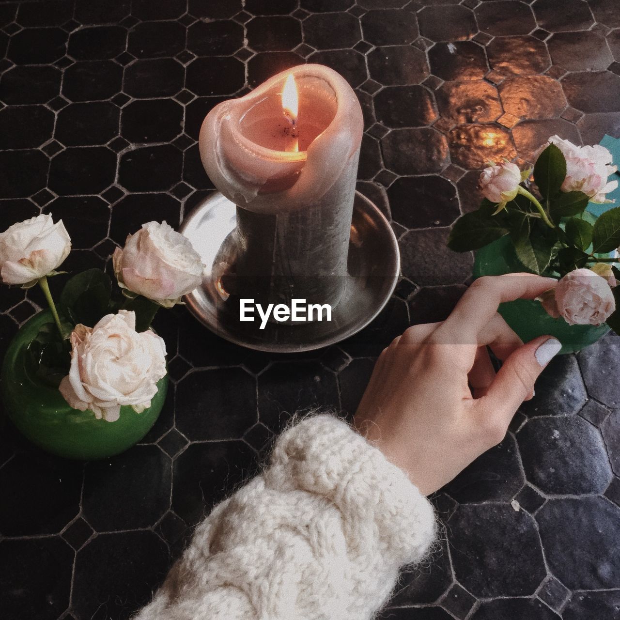 Cropped image of woman touching flower