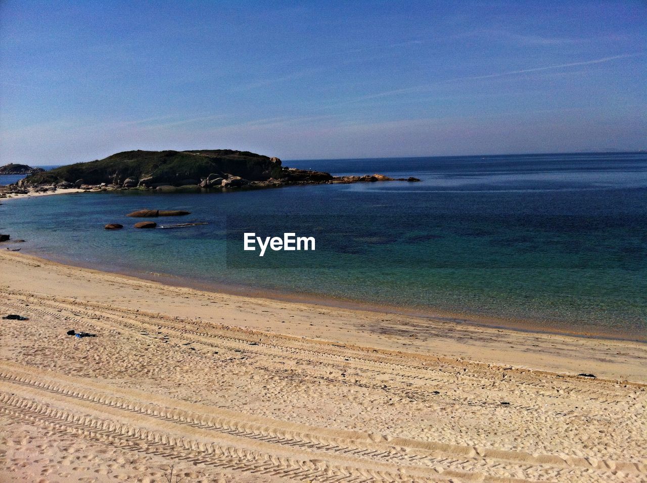 Scenic view of beach against blue sky