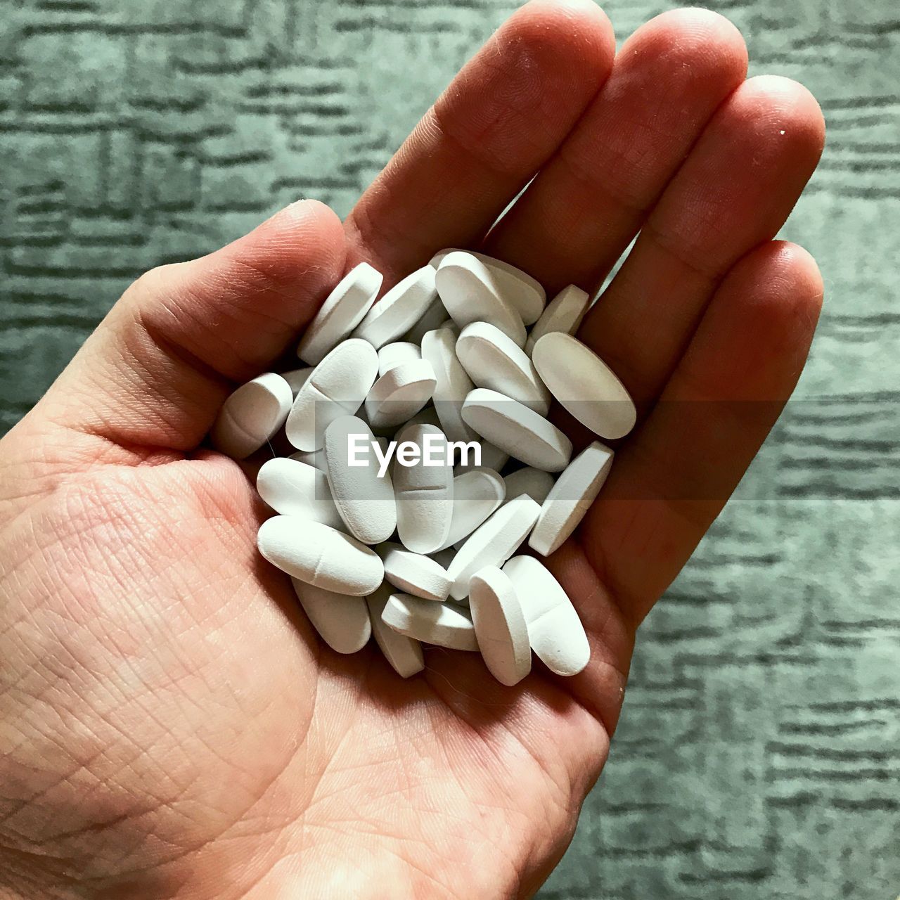 Cropped hand holding medicines
