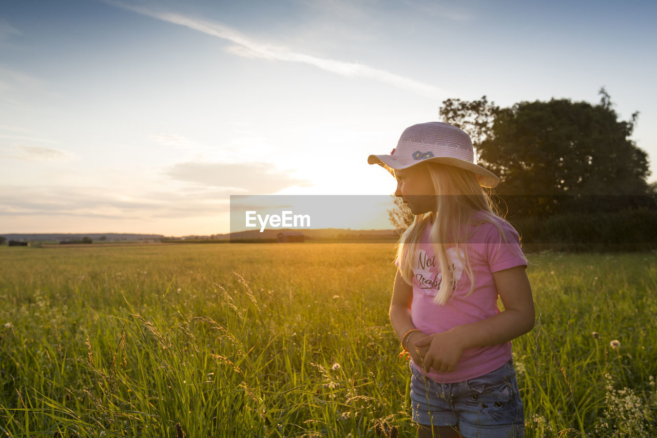 FULL LENGTH OF GIRL ON FIELD AGAINST SKY