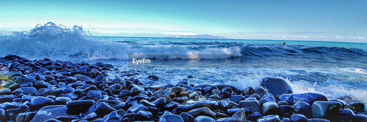 WAVES SPLASHING ON ROCKS AT BEACH