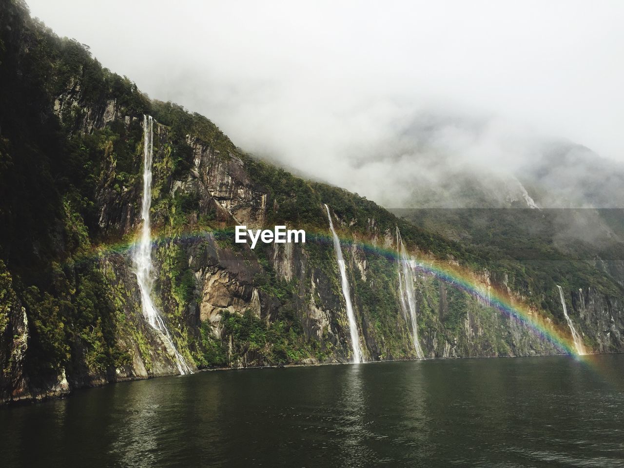 Low angle view of waterfall against sky