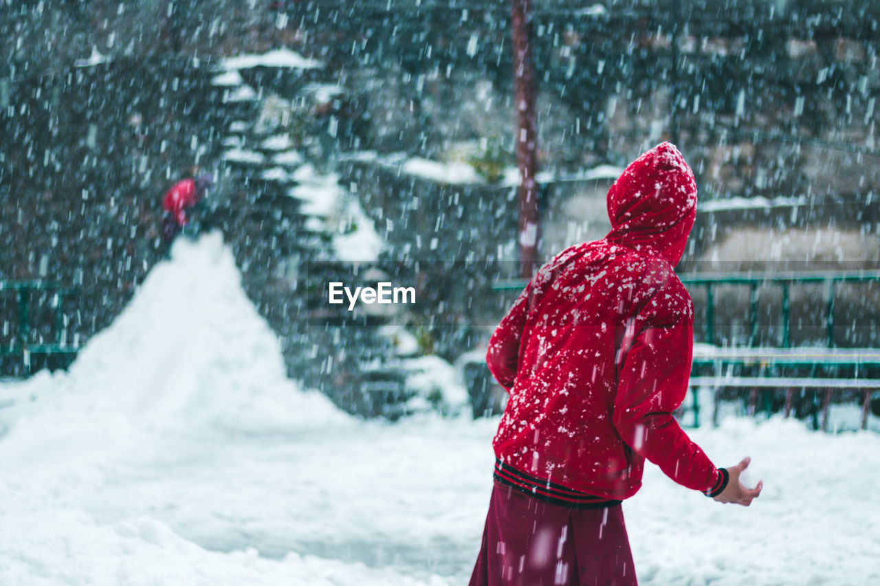 Rear view of a man standing on snow