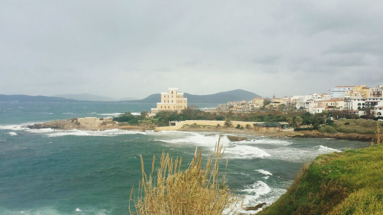 High angle view of calm blue sea along buildings