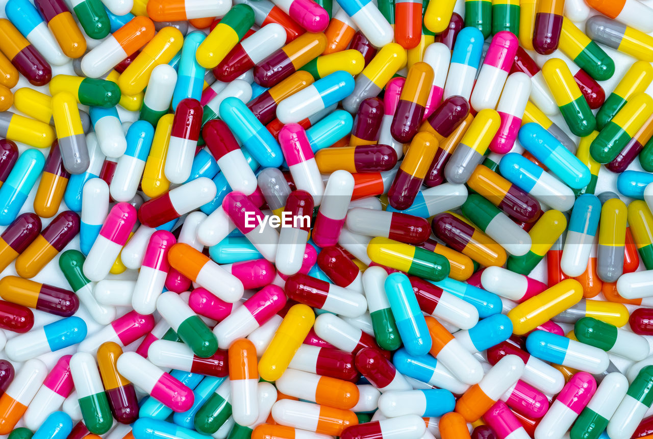 Many capsule pills. top view capsule pills. full frame blue, yellow, green, pink, red, orange pills.