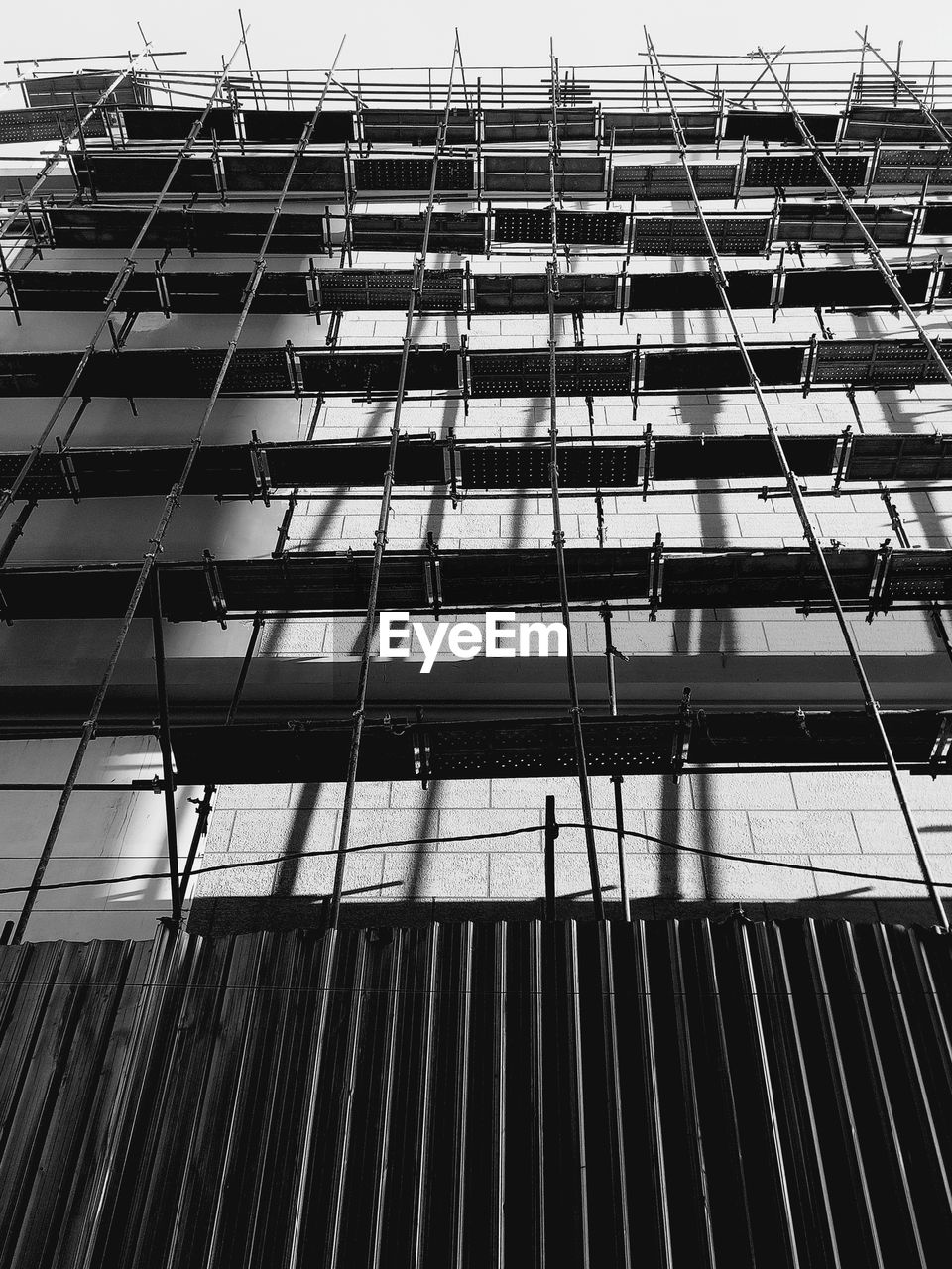 LOW ANGLE VIEW OF GLASS BUILDING WITH REFLECTION