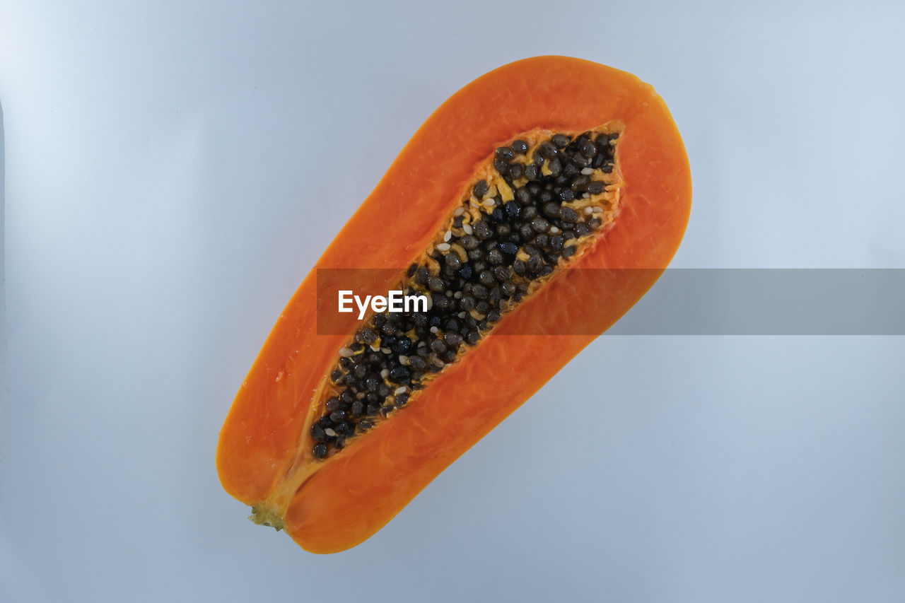 Close-up of papaya slice against white background