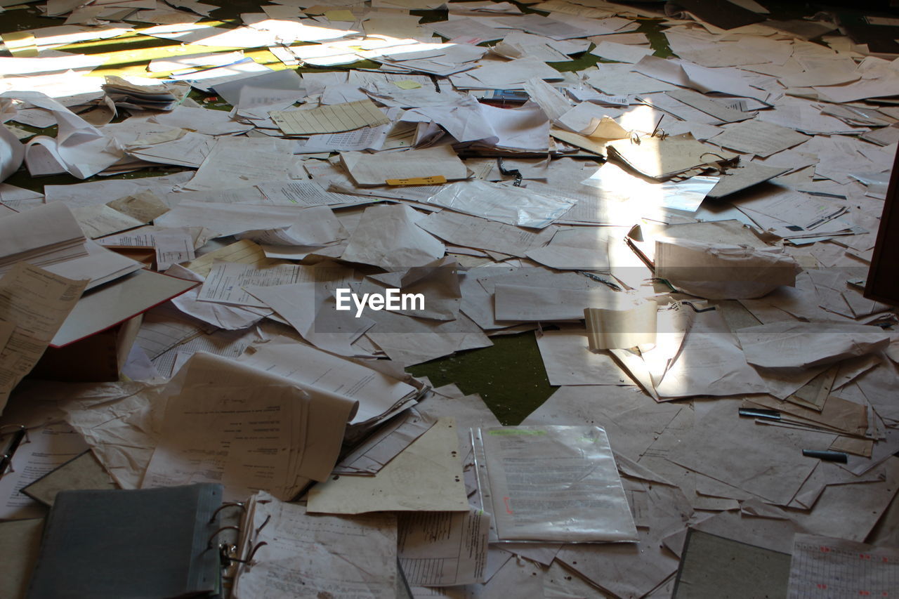 Full frame shot of abandoned papers on floor