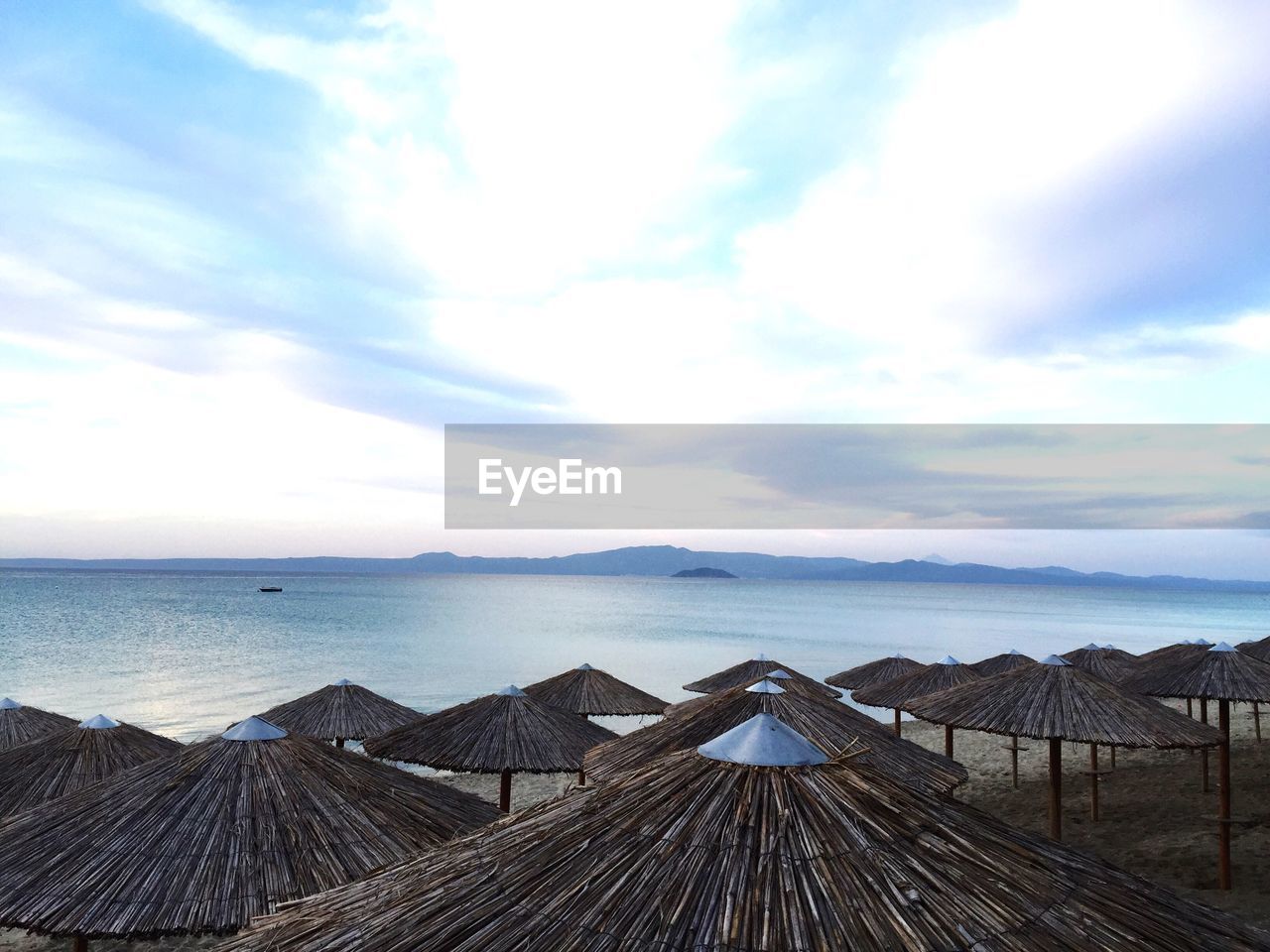 High angle view of thatched roofs on calm beach