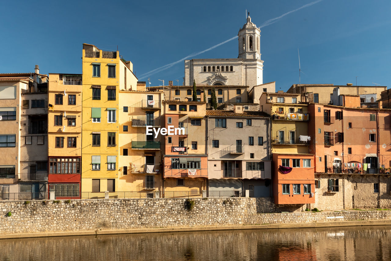 Eflections in the water to the colorful buildings and historic charm, girona in catalunya, spain, 