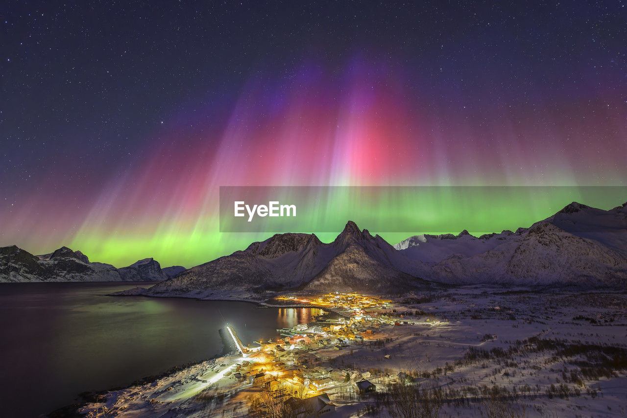 Norway, troms og finnmark, mefjordvaer, northern lights over remote fishing village on senja island