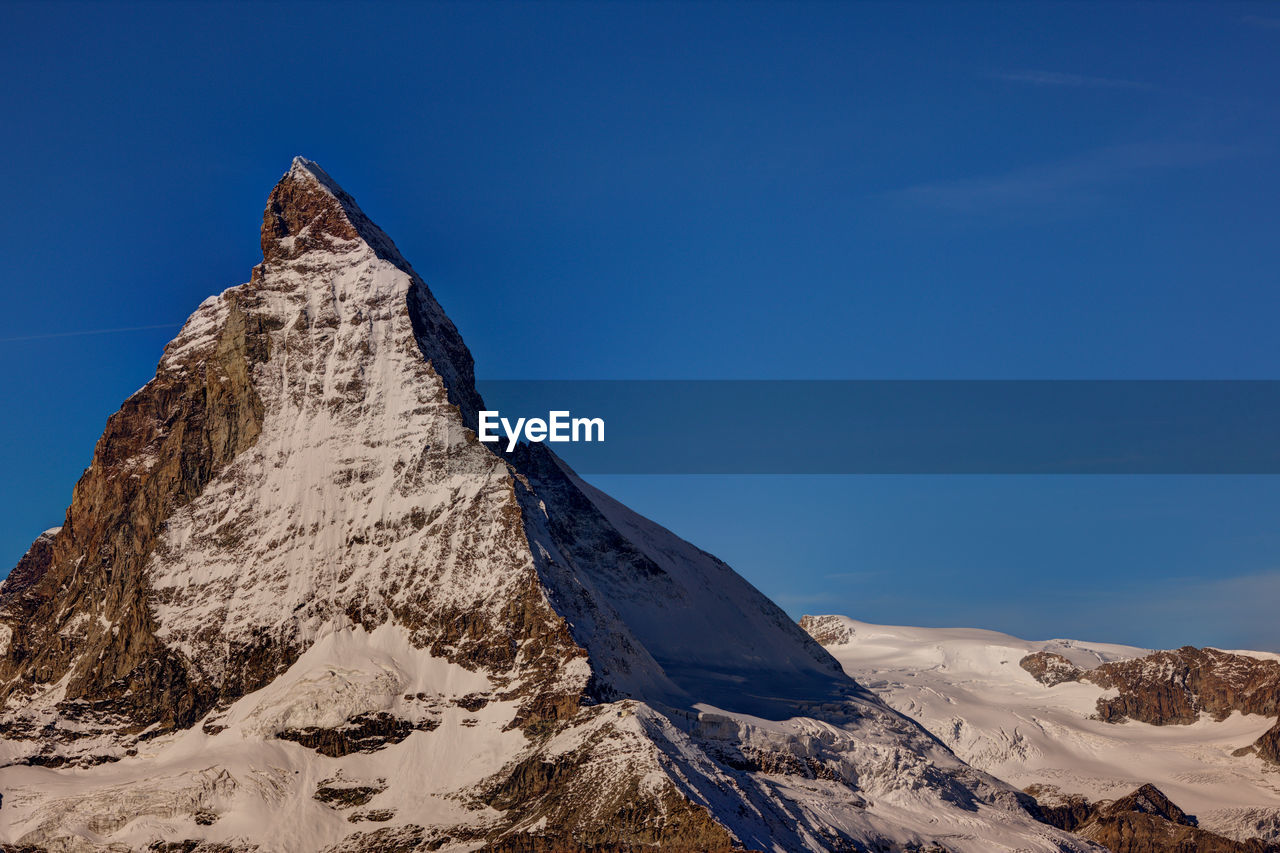 Scenic view of snow covered mountains against sky