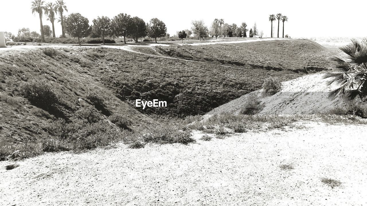 Scenic view of hill against sky