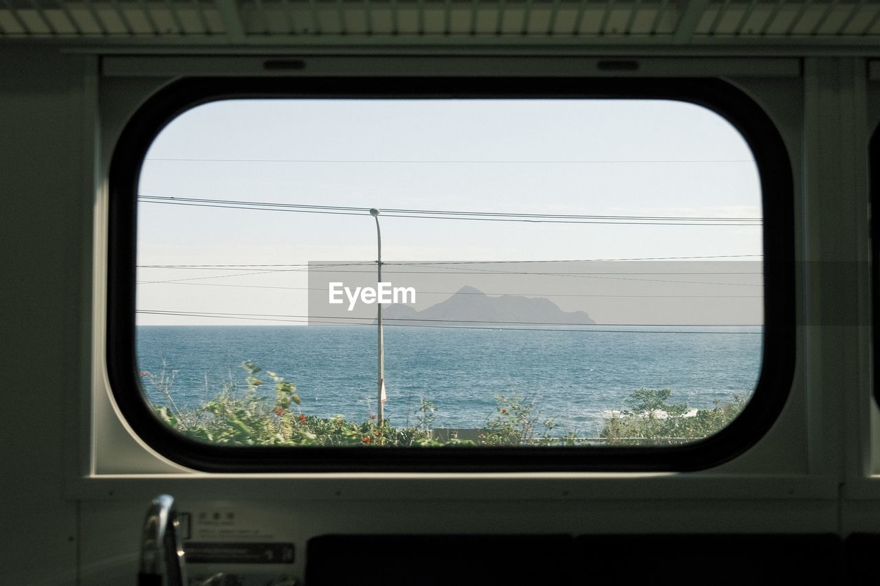 View of sea seen through train window