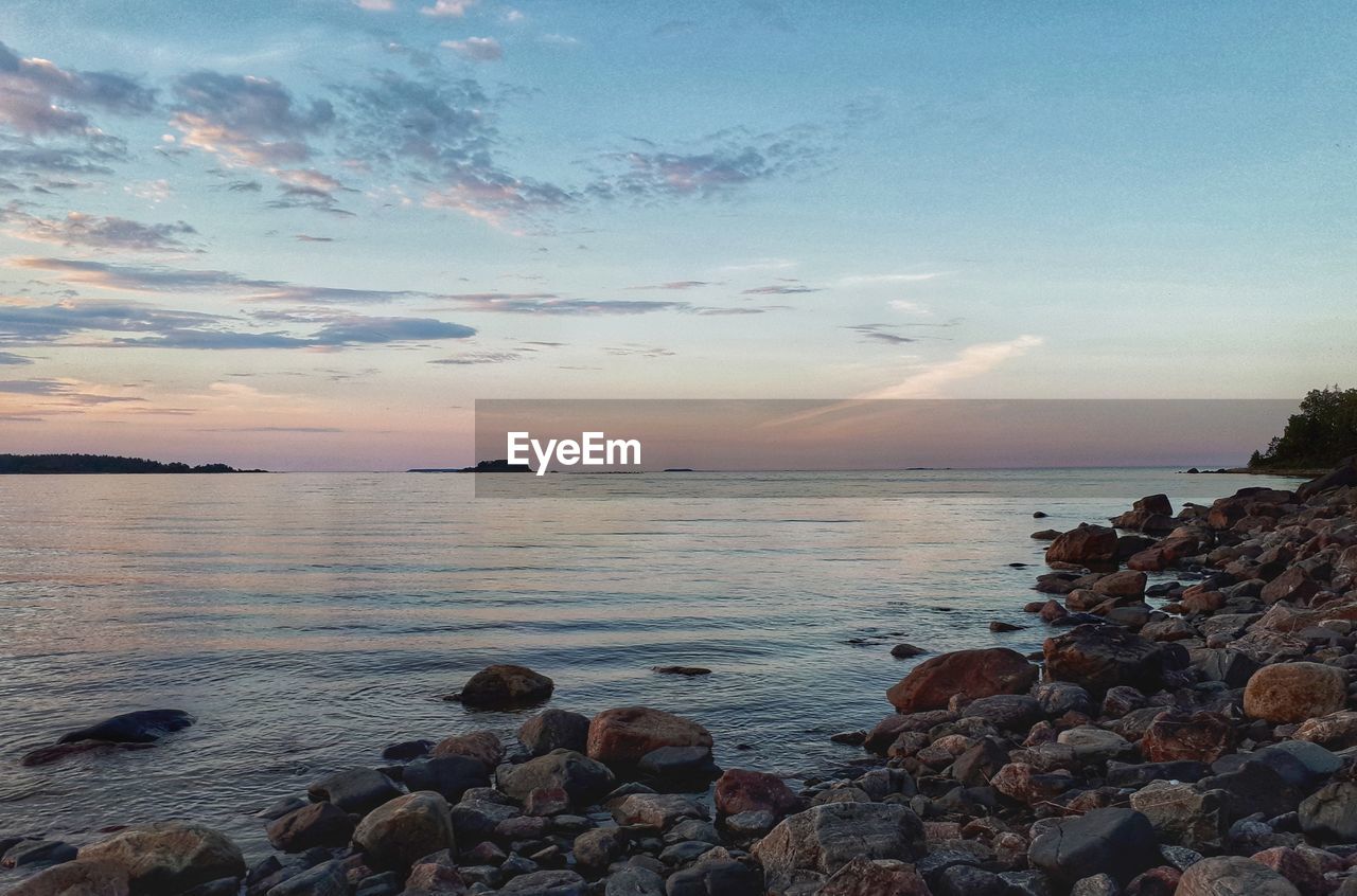 SCENIC VIEW OF SEA AT SUNSET