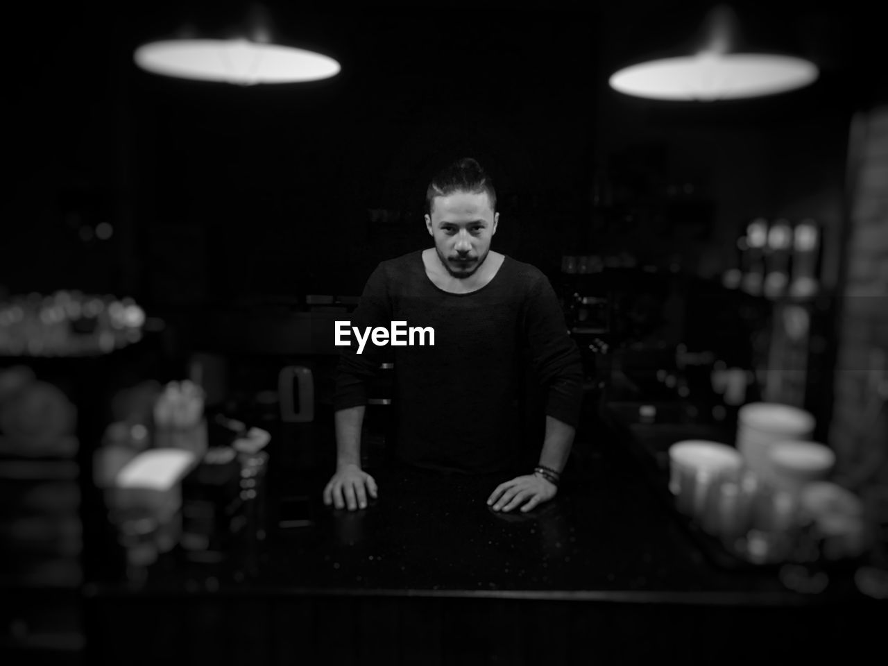 Portrait of man standing at bar counter