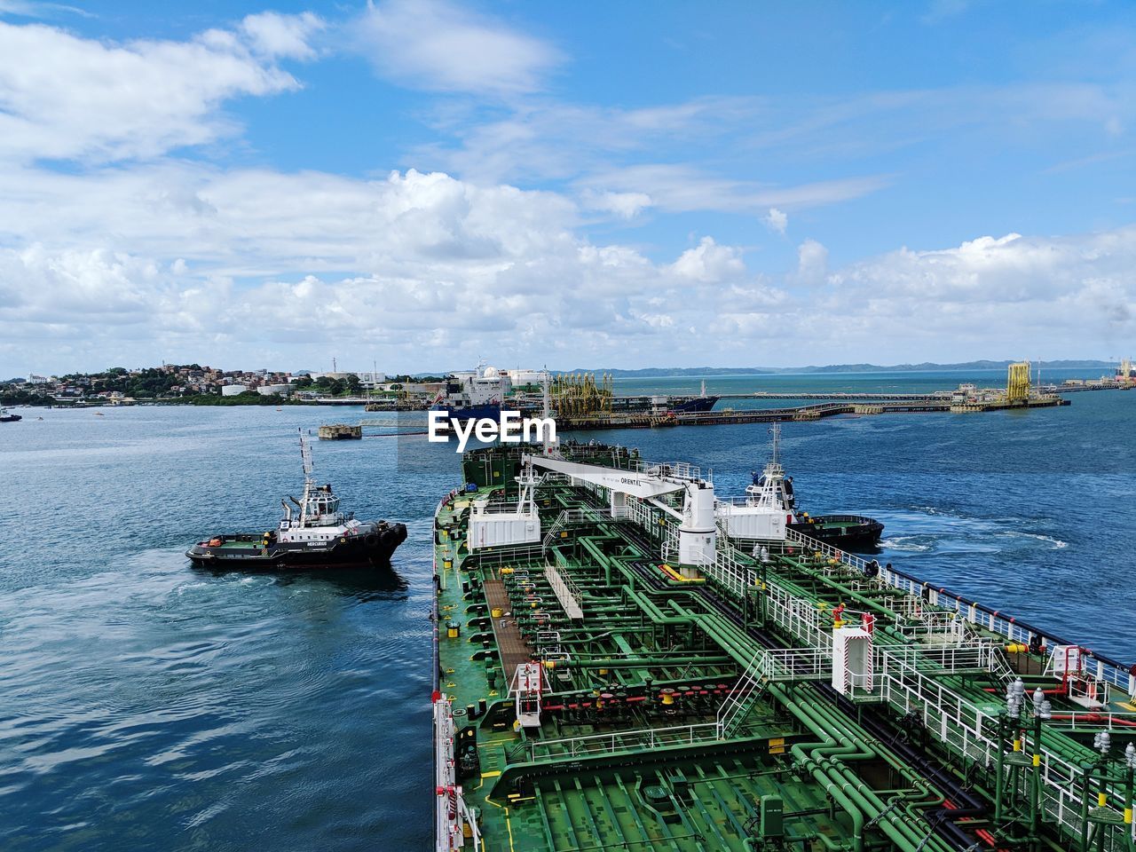 High angle view of ship moored at harbor against sky