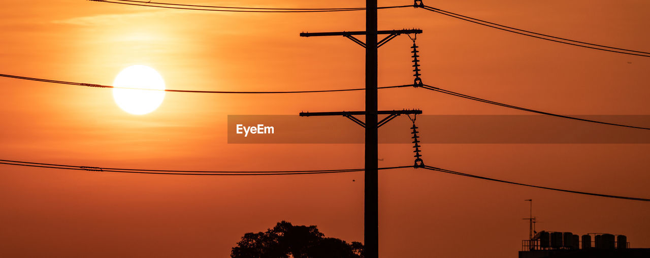 High voltage electric transmission pylon. high voltage power lines against sunset sky. electricity