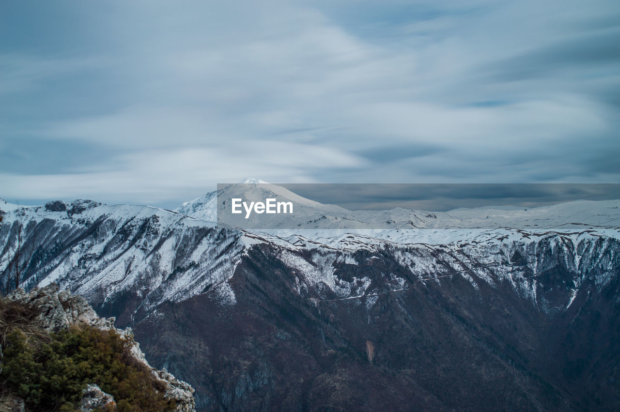 Scenic view of snowcapped mountains against sky