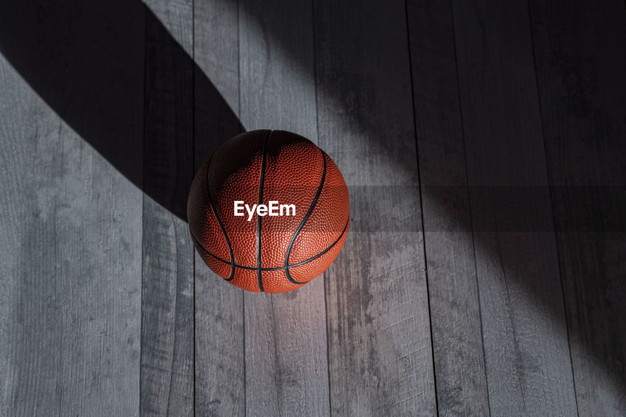 High angle view of basketball on hardwood floor