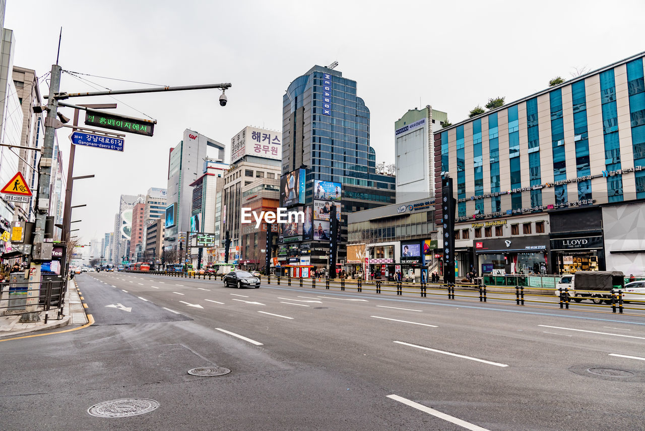 Road by buildings in city