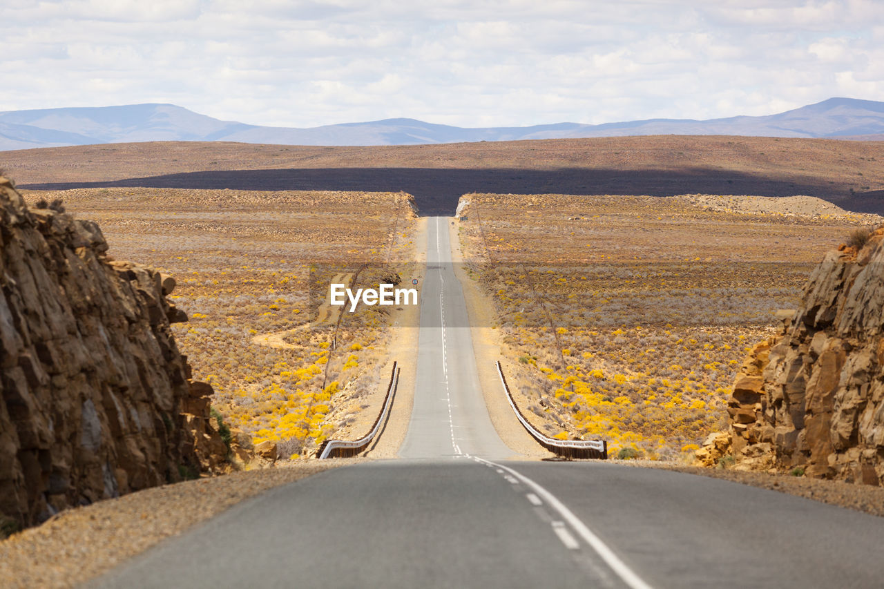 PANORAMIC VIEW OF ROAD AMIDST LANDSCAPE AGAINST SKY