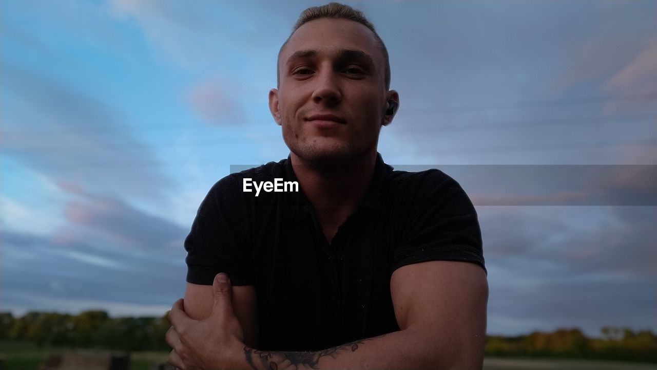 Portrait of man looking away against sky