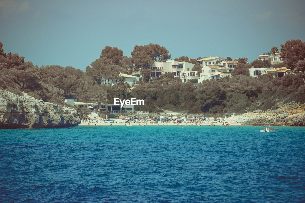 SCENIC VIEW OF SEA AGAINST BUILDINGS