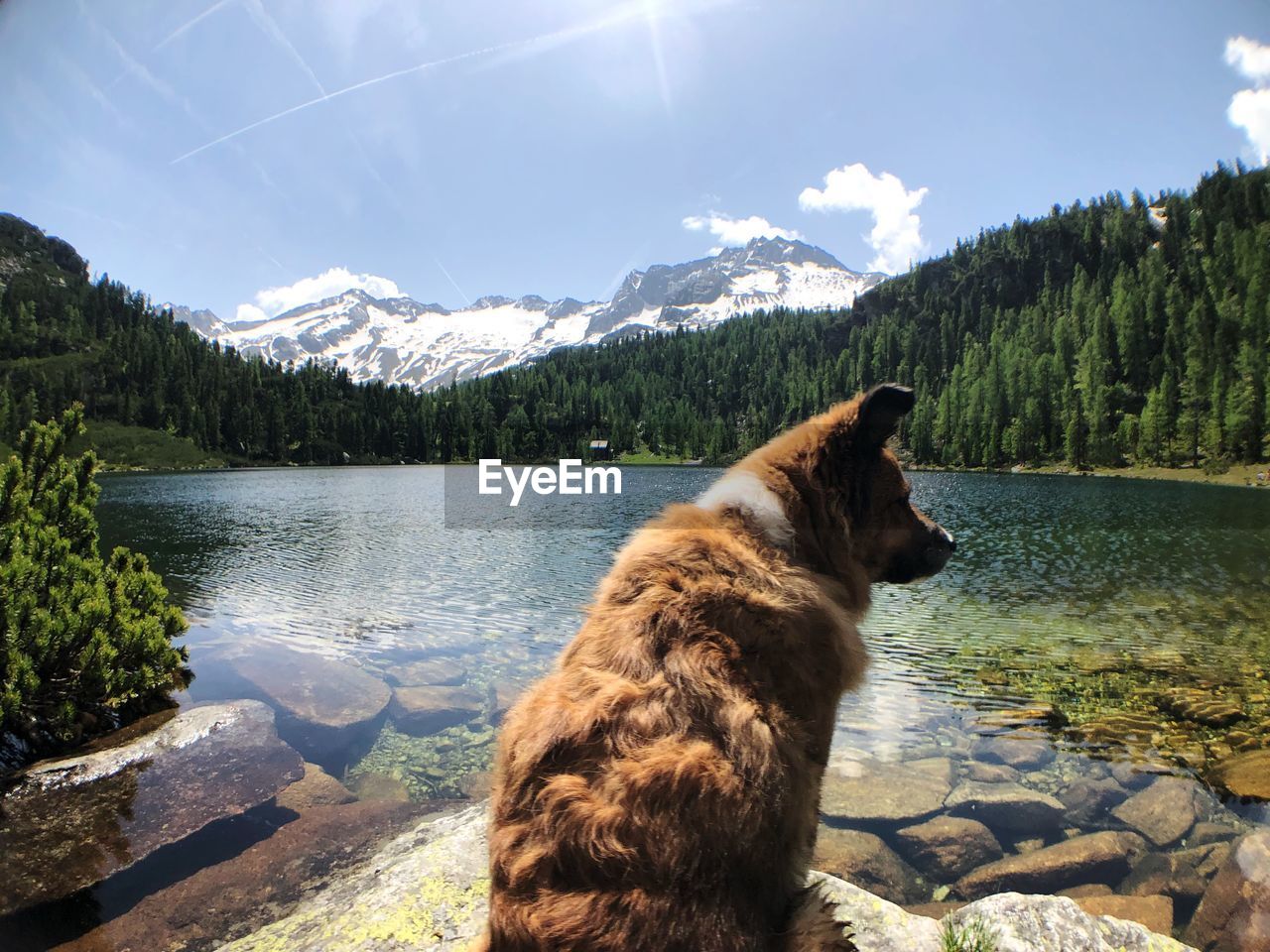 Scenic view of lake by mountain against sky