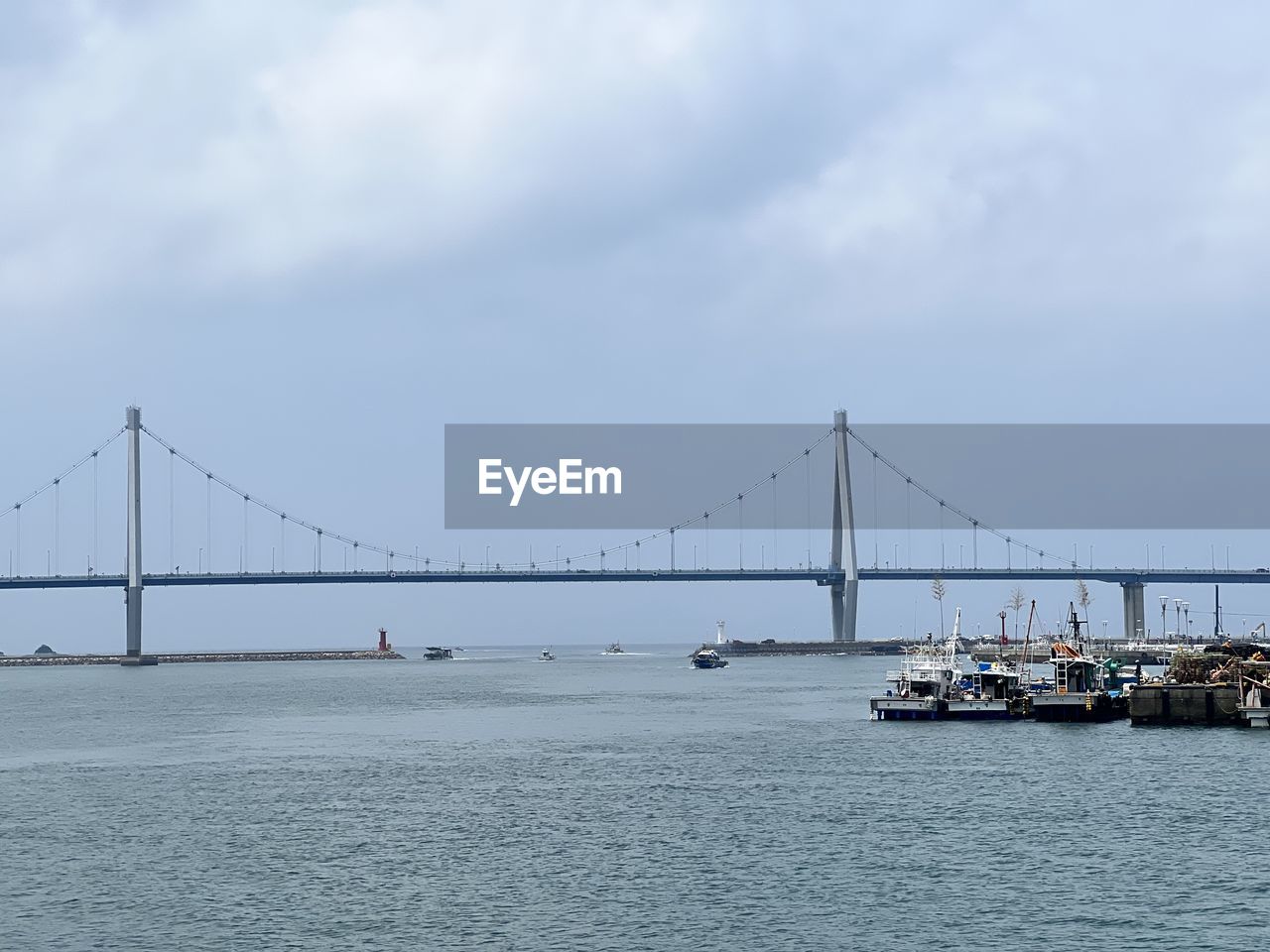 bridge, transportation, architecture, water, built structure, suspension bridge, sky, engineering, travel destinations, sea, travel, tourism, nature, city, cloud, copy space, dramatic sky, mode of transportation, bay, beauty in nature, nautical vessel, bay of water, atmospheric mood, cityscape, tranquil scene, scenics - nature, tranquility, cable-stayed bridge, building exterior, day, outdoors, fog, overcast, landscape, shipping, industry, business finance and industry, environment, idyllic, vehicle, man made, urban skyline, horizon, waterfront, moody sky, city life, business, ship, panoramic, construction equipment, freight transportation, long, road, holiday, beach, building, construction industry, alloy, highway, large, steel, architectural feature, boat, cargo container, water's edge, rippled, coastline, land