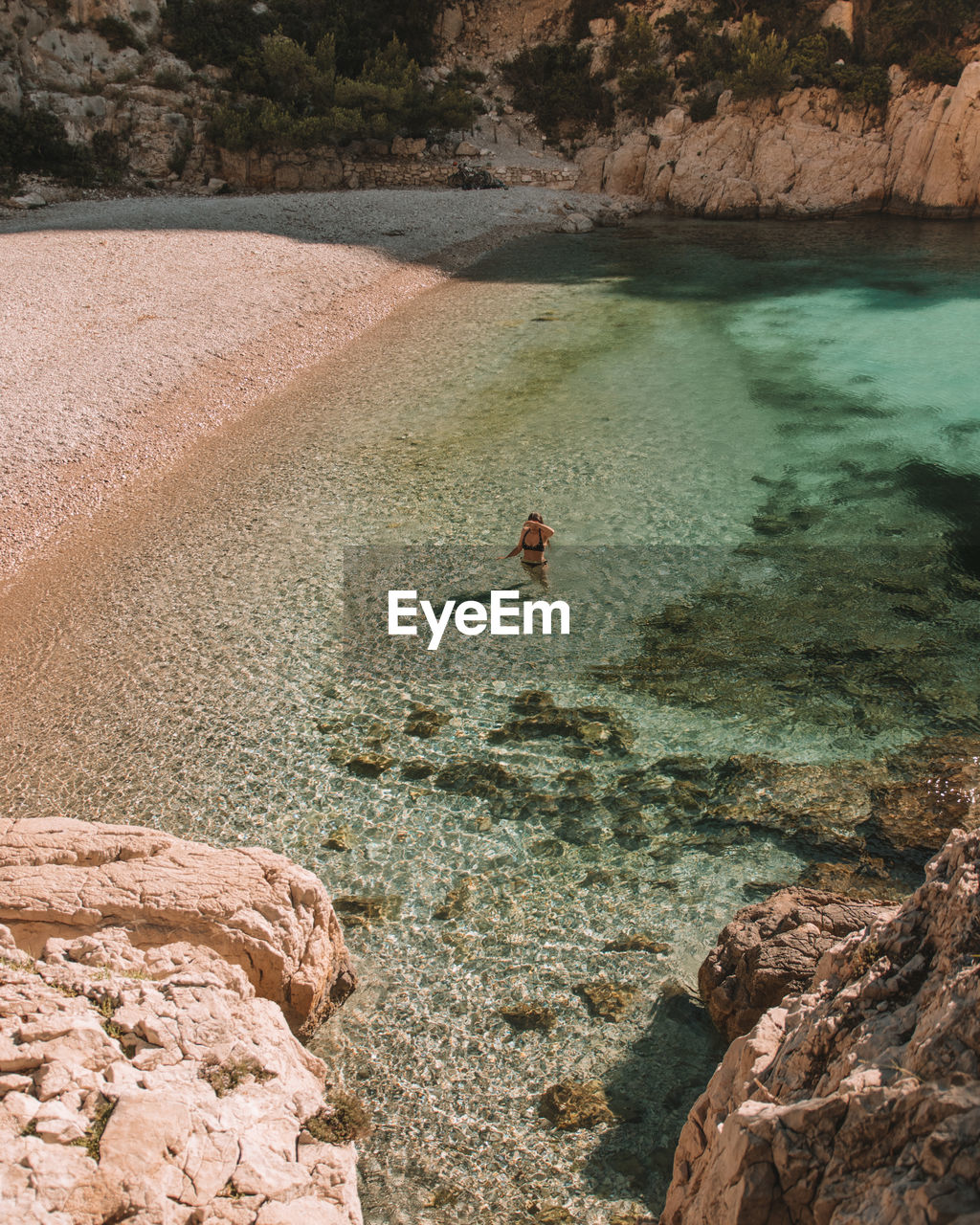 High angle view of woman standing on beach