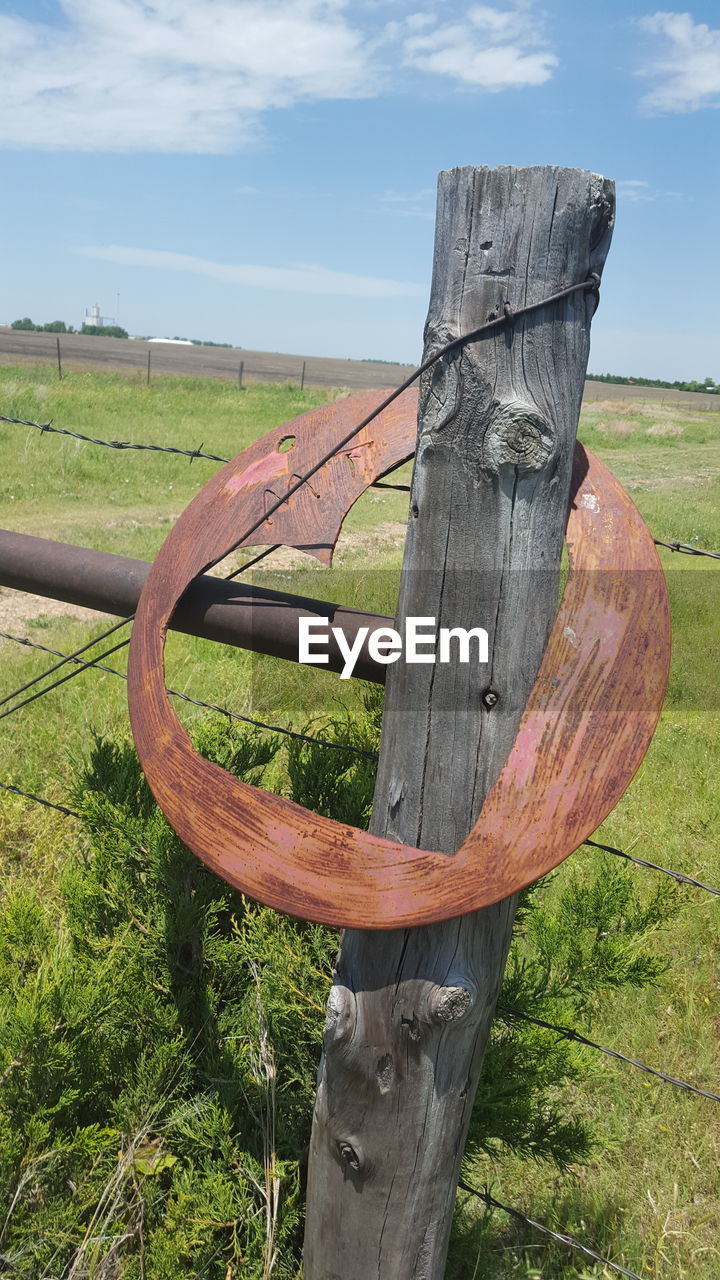 OLD WOODEN STRUCTURE ON GRASSY FIELD