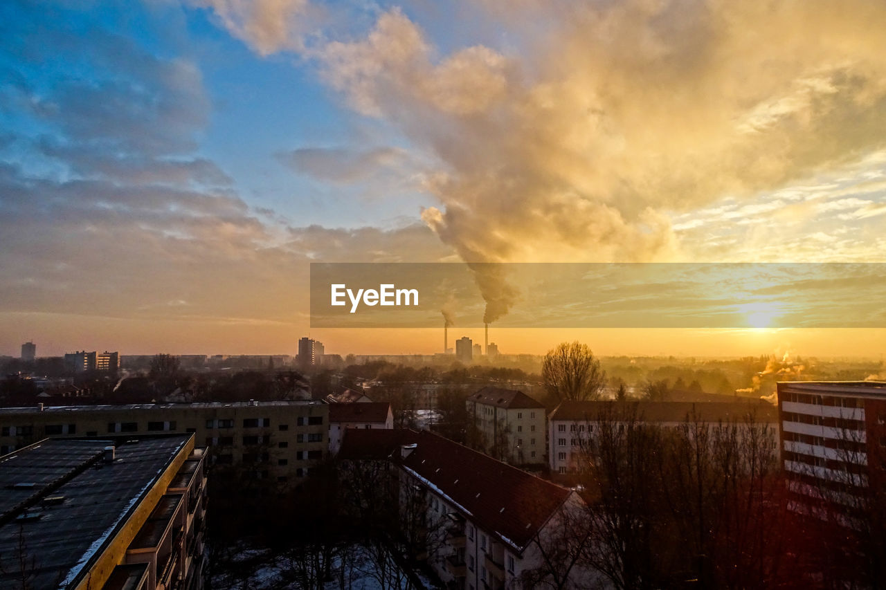 Residential buildings against polluted air at sunset