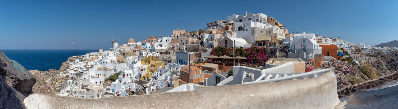 Panoramic view of buildings against blue sky