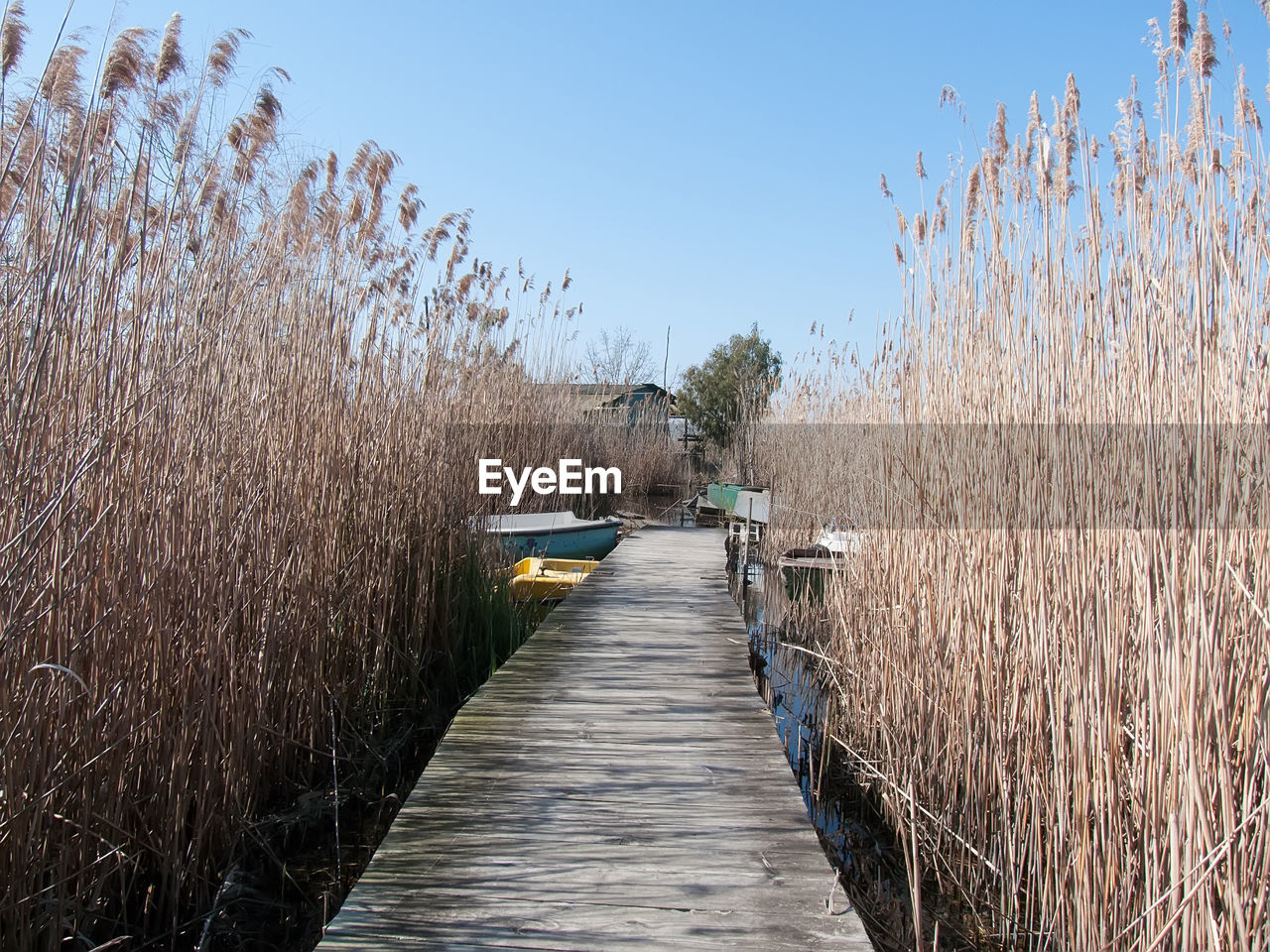 BOARDWALK AGAINST CLEAR SKY