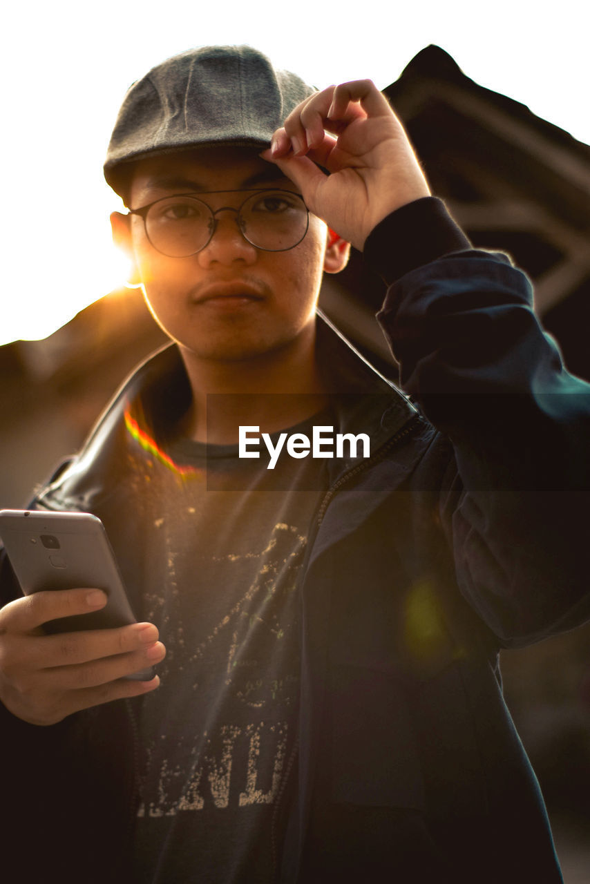 Portrait of young man using mobile phone