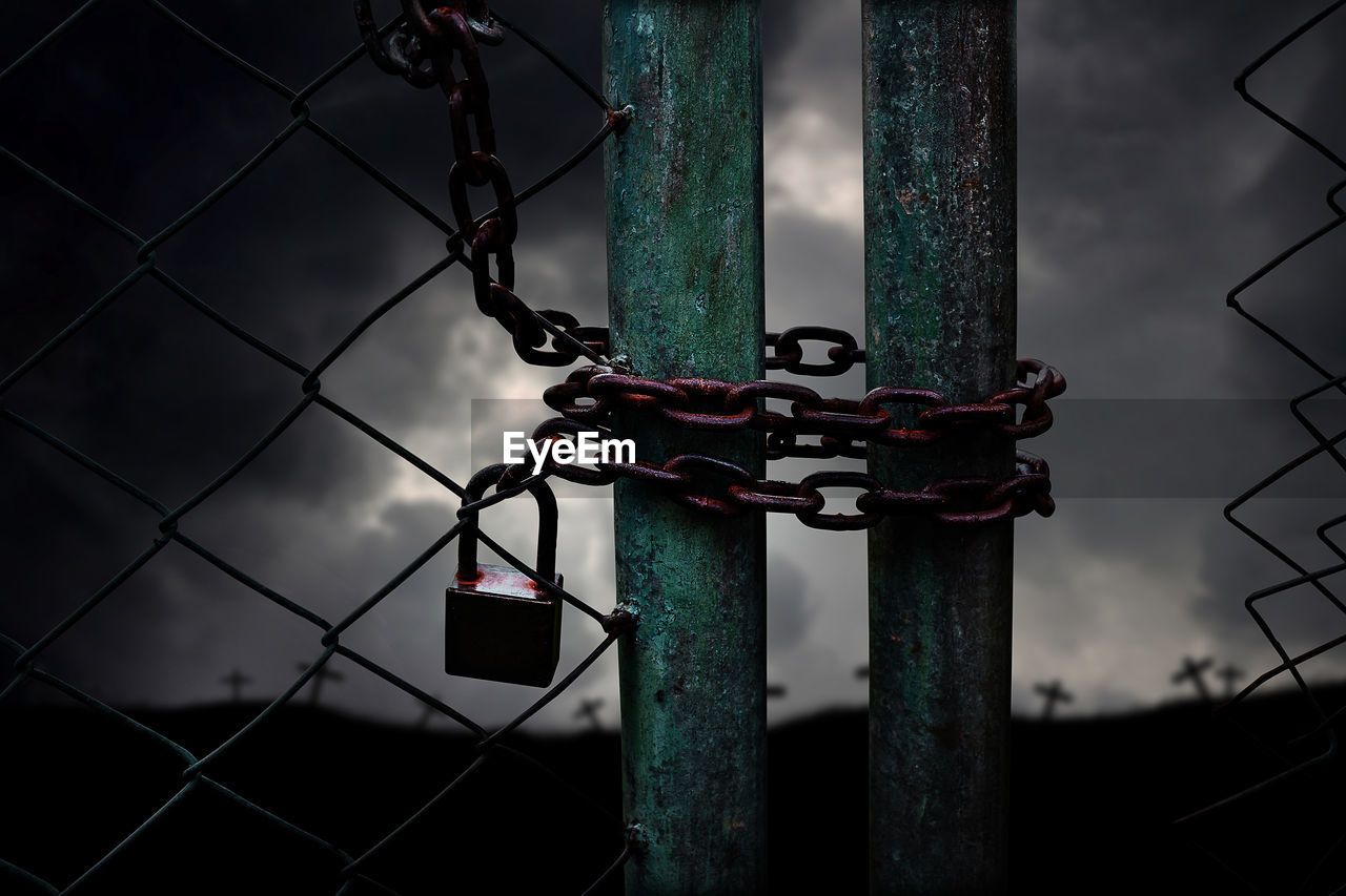 security, protection, fence, darkness, metal, lock, chainlink fence, light, chain, no people, padlock, gate, screenshot, architecture, wire fencing, outdoors, iron, black, security system, sky, close-up, nature, wire, barbed wire