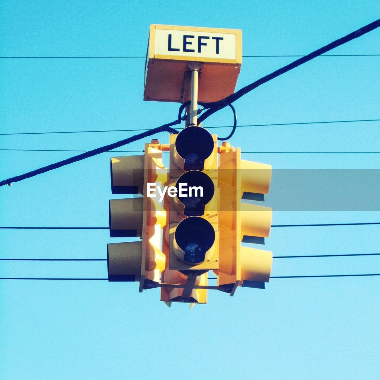Low angle view of traffic light against blue sky