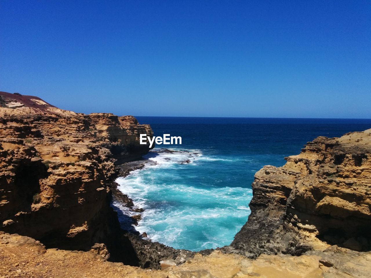 Scenic view of sea against clear blue sky