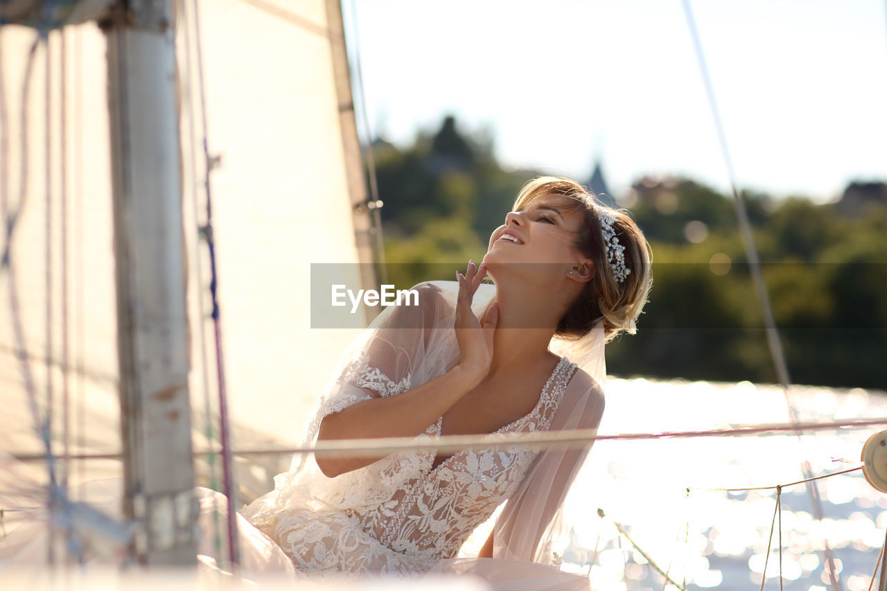 Bride on a sailing yacht in the rays of the setting sun