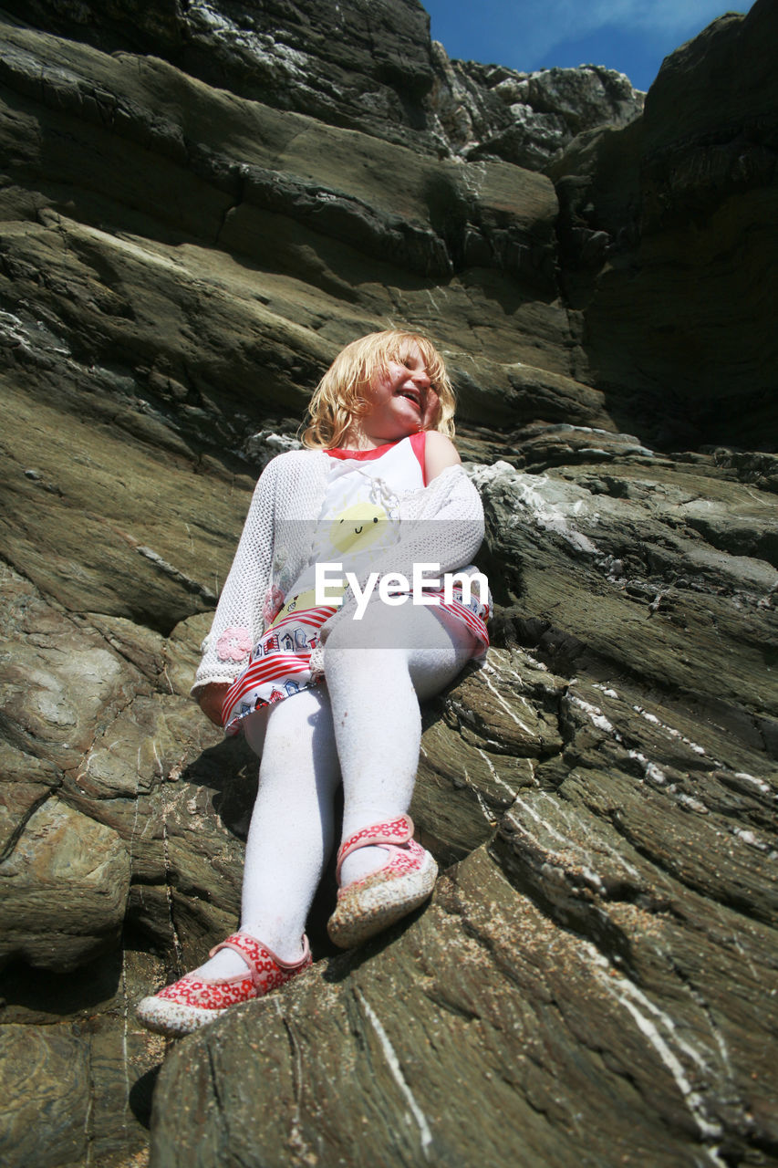 Girl sitting on rock