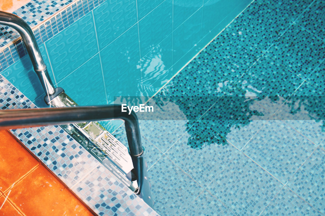High angle view of ladder at poolside