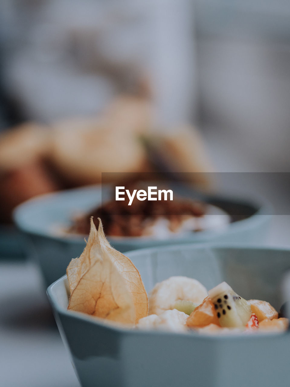 Close-up of fruit in a bowl, with a breakfast bar in the background. 