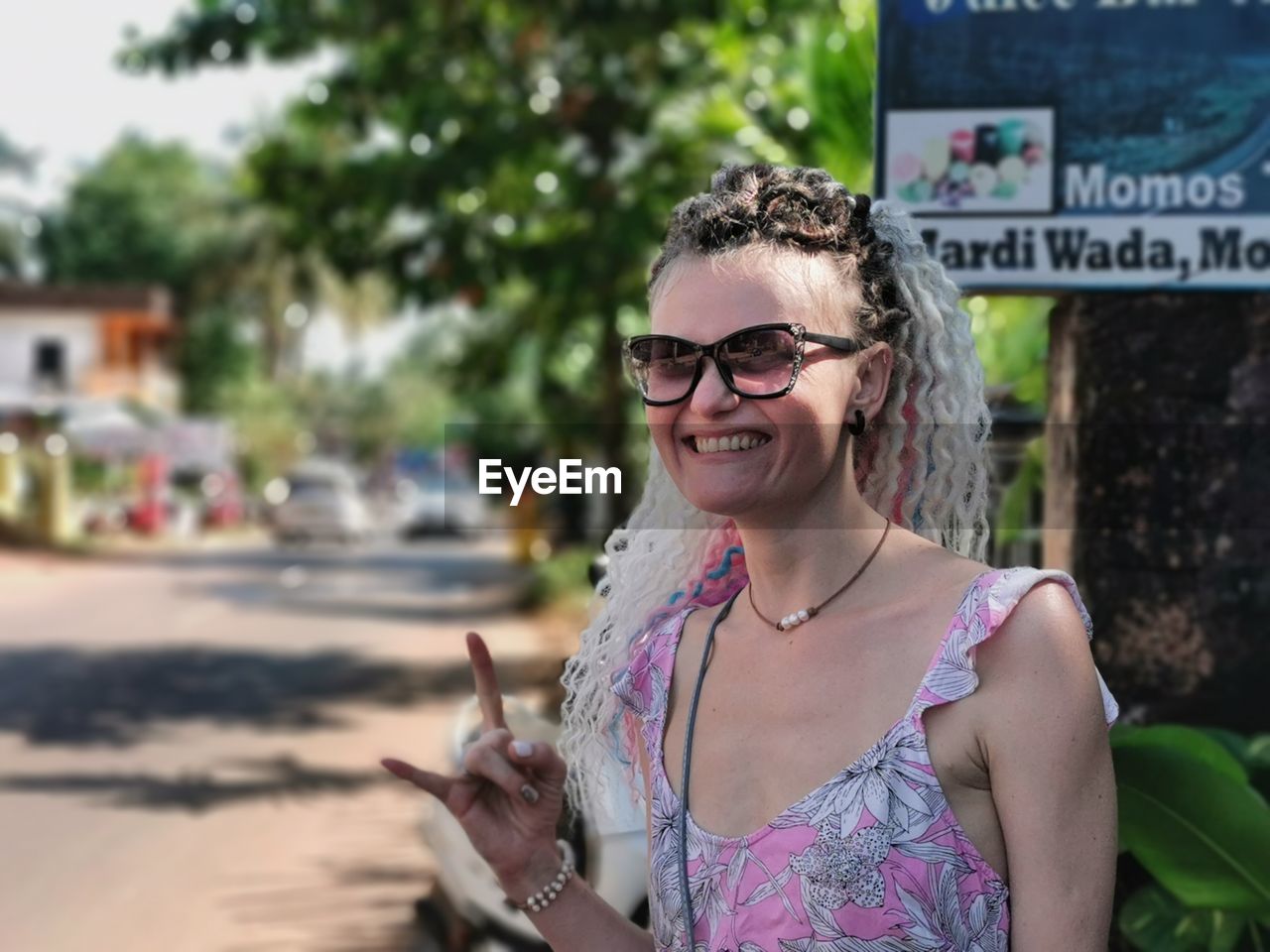 Portrait of smiling young woman wearing sunglasses