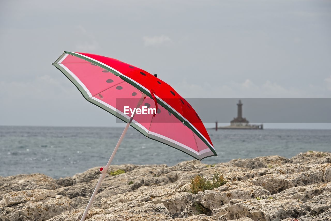 RED UMBRELLA ON BEACH