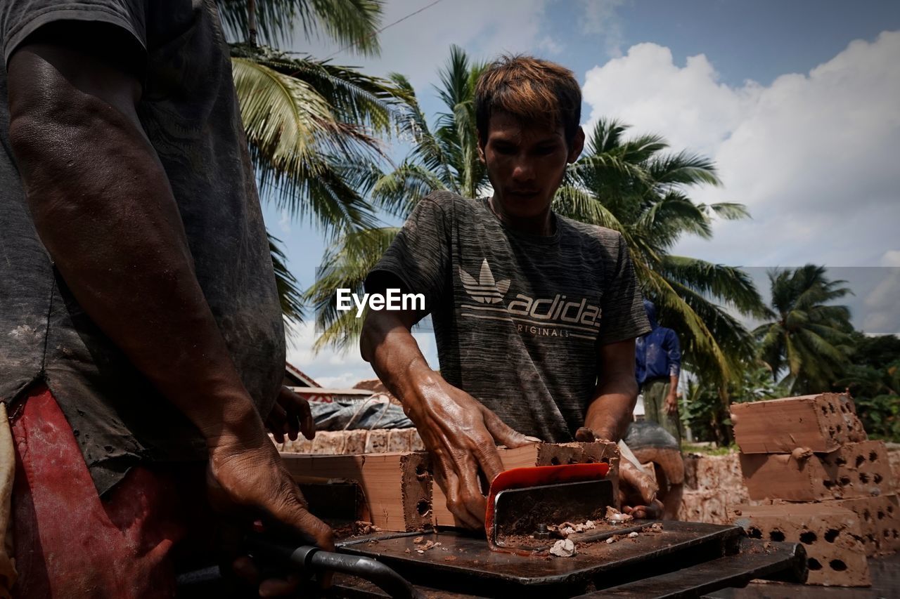 MAN WORKING IN TRADITIONAL CLOTHING